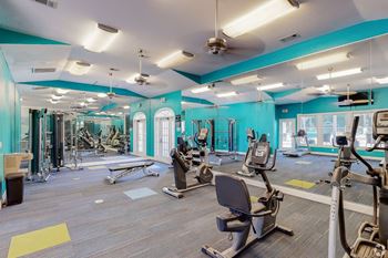 Fitness center with cardio and resistance equipment at Grande View Apartments in Biloxi, MS